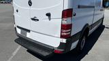 A 2016 Mercedes-Benz Sprinter van with a white exterior and red taillights is shown from a rear angle showcasing its back and bumper design