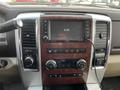 Dashboard of a 2010 Dodge Ram featuring a touchscreen display and various control buttons for audio and climate functions