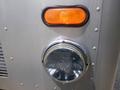 Close-up of a 2007 Morgan Olson Workhorse W42 showing a chrome headlight and an orange marker light