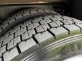 Close-up of two worn truck tires with detailed tread patterns showcasing their usage and age