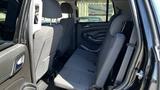 The interior of a 2018 Chevrolet Tahoe showing the back row of seats with gray upholstery arranged for spacious seating.