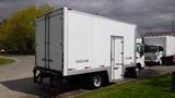 A 2016 Hino 195 box truck with a white exterior and a rear cargo area featuring a side door