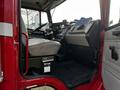 Interior of a 1994 Freightliner FL80 showing the driver's seat dashboard and controls