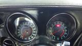 Dashboard of a 1971 Chevrolet Corvette Stingray featuring speedometer and tachometer gauges with a sleek black finish