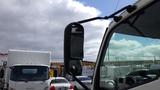 A 2016 Hino 195 truck with a side mirror prominently displayed in the foreground