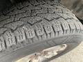 Close-up of a 2014 Ford F-150 tire showing detailed tread pattern and wear on the rubber surface