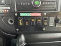 Control panel with buttons labeled for air clearance, door ajar, interior light, interior delay, deploy, ramp, and stow functions on a 2017 Chevrolet Express