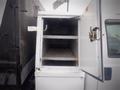 The image shows the open door of a white service body on a 2008 Ford F-550 revealing empty storage shelves inside