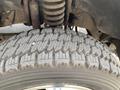Close-up of a heavily treaded tire from a 2010 Ford F-550 showing a rugged design and deep grooves for traction