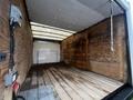 A 2017 Ford Econoline van with an empty cargo area featuring wooden floors and walls