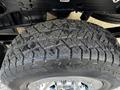 Close-up of a 2017 GMC Sierra 1500 tire showcasing its tread pattern and shiny rim