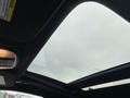 A panoramic sunroof of a 2018 Jeep Grand Cherokee showing cloudy sky above