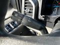 Close-up of a 2017 Ford F-150 windshield wiper control lever showing various settings for wipers and headlights
