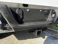 Rear view of a 2017 Ford F-150 truck showing the hitch receiver and electrical connections mounted on the bumper