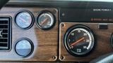 Dashboard of a 1995 Freightliner FLL086 featuring gauges for water temperature oil pressure and RPM along with an indicator for shore power