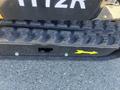 Close-up of the rubber track of a 2024 AGT Mini Excavator featuring distinct tread patterns and a yellow directional arrow indicating movement