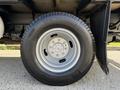 A close-up view of a silver wheel and tire from a 2016 Ford F-350 SD showcasing the tire tread and rim design