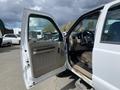 A 2010 Ford F-550 with the driver's side door open revealing the interior including a steering wheel and dashboard.