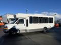 2012 Chevrolet Express bus with a sleek white exterior and large windows on the side