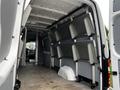 Interior cargo area of a 2016 Mercedes-Benz Sprinter van featuring mounted metal shelving along the walls