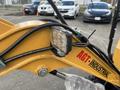 Close-up of a yellow 2024 AGT Mini Excavator arm with a mounted LED work light and hydraulic tubing visible