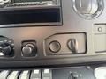 Close-up of the dashboard controls of a 2010 Ford Econoline showing knobs and buttons for various functions and settings