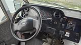 Interior view of a 2006 Ford Econoline showing the steering wheel dashboard gauges and control panels