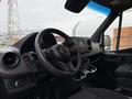 Interior view of a 2019 Mercedes-Benz Sprinter showcasing the steering wheel dashboard and console with infotainment system and gear shift