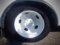 Close-up of a white wheel from a 2006 Freightliner FS65 featuring a five-bolt pattern and a tire labeled as STA230