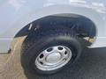 Close-up of a tire and wheel of a 2013 Ford F-150 showing the tread pattern and alloy rim