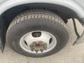 Close-up of a wheel and tire from a 2017 Chevrolet Express showcasing the tread pattern and lug nuts on a steel rim