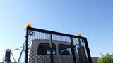 A 2007 Sterling Acterra L7500 truck with a mesh grille and yellow lights on top in a clear blue sky