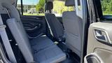 Interior view of a 2018 Chevrolet Tahoe showing the back seating area with two rows of grey fabric seats folded down