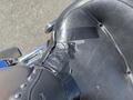 Black leather motorcycle seat with visible wear and black tape repairs on the side