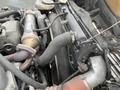 Close-up of the engine components of a 2008 Hino 268 featuring hoses and a turbocharger with metallic and rubber parts detailed