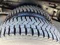 Close-up of a large tire from a 2012 Ford Econoline showing the tread pattern and sidewall details