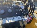 The control panel of a 2024 AGT KTT23 Mini Skid Steer featuring gauges switches and key fobs with various labels and indicators