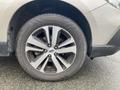 A close-up view of a silver 2019 Subaru Outback wheel with a tire showing detailed alloy spokes and tread pattern