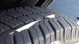 Close-up of a treaded tire showing detailed grooves and patterns typical of a 2012 GMC Savana tire