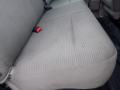 A beige fabric seat from a 2009 Ford F-450 SD with visible textures and a seatbelt buckle on the side