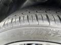 A close-up of a tire from a 2017 Dodge Challenger showing the tread pattern and size information