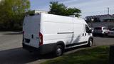 A white 2017 RAM Promaster van viewed from the rear with a sliding side door and no visible branding or markings