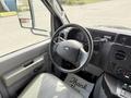 Interior view of a 2010 Ford Econoline showing the steering wheel dashboard with gauges and control buttons
