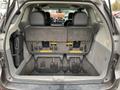 The rear interior of a 2013 Toyota Sienna showing folded third-row seats with a view into the spacious cargo area