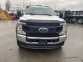 Front view of a 2021 Ford F-550 with a black grille and silver body showing the Ford logo on the front