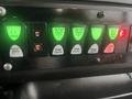 Control panel of a 2017 Chevrolet Express featuring multiple switches for lights with green and red indicators