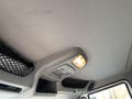 Interior view of a 2013 International 4300 showing the overhead console with a light and storage netting