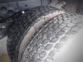 The image shows two large, heavily treaded tires of a 2008 Ford F-550 showcasing their rugged texture and wear