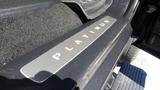 A close-up view of the stainless steel door sill plate of a Ford F-350 SD inscribed with the word PLATINUM