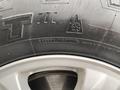 Close-up of a tire on a 2017 Ford F-150 showing tread and sidewall markings including safety warning and manufacturer information